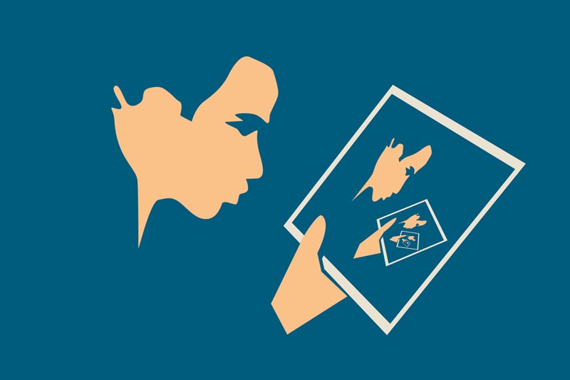 Portrait of a man looking at a photograph in which his own portrait appears looking at a photograph in which his own portrait appears.